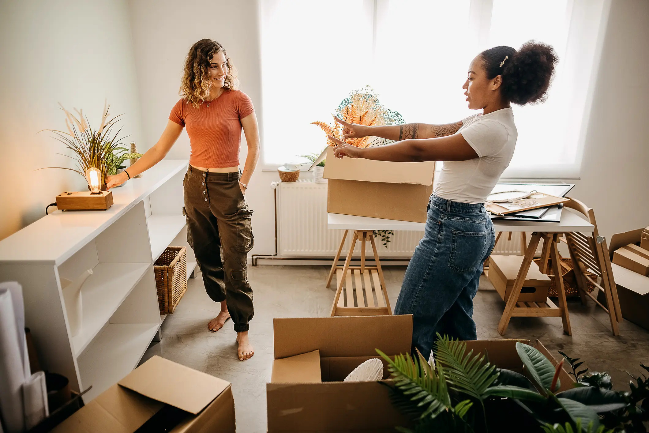 Two students preparing a furnished sublet space for move-in.